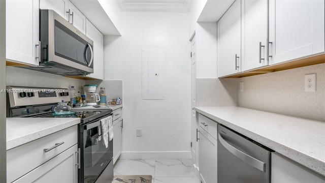 kitchen featuring ornamental molding, white cabinetry, electric panel, and stainless steel appliances