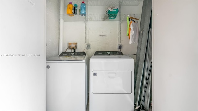 clothes washing area featuring independent washer and dryer