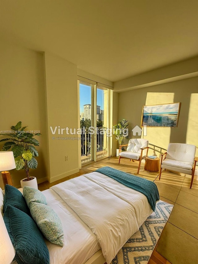 bedroom with access to outside, a view of city, and baseboards