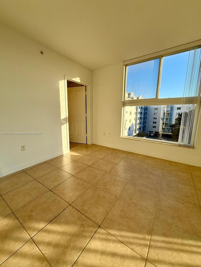 tiled empty room with baseboards