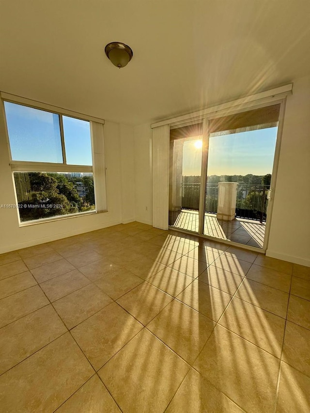 spare room featuring light tile patterned floors and a wealth of natural light