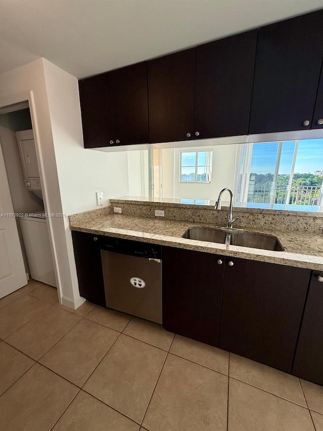 kitchen featuring a sink, light stone countertops, stainless steel dishwasher, and light tile patterned flooring