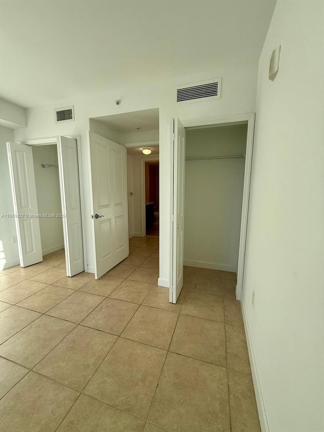 unfurnished bedroom featuring light tile patterned flooring