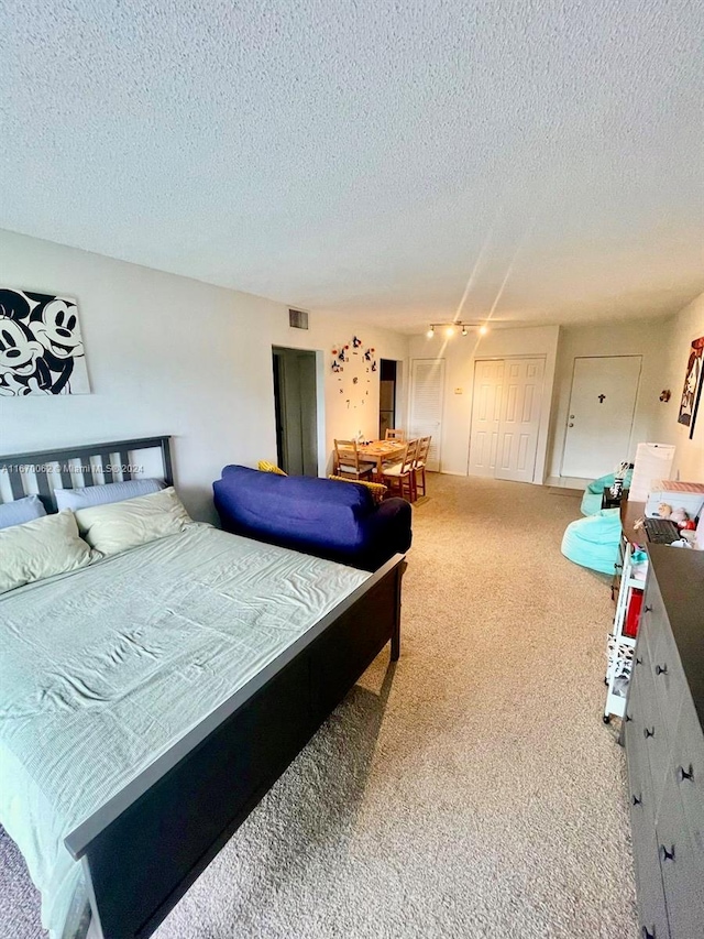 carpeted bedroom featuring a textured ceiling