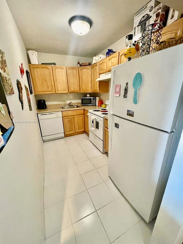 kitchen with light tile patterned floors, light brown cabinets, sink, and white appliances