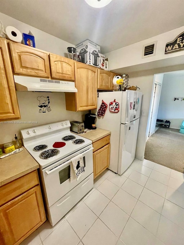 kitchen with white appliances and light tile patterned floors