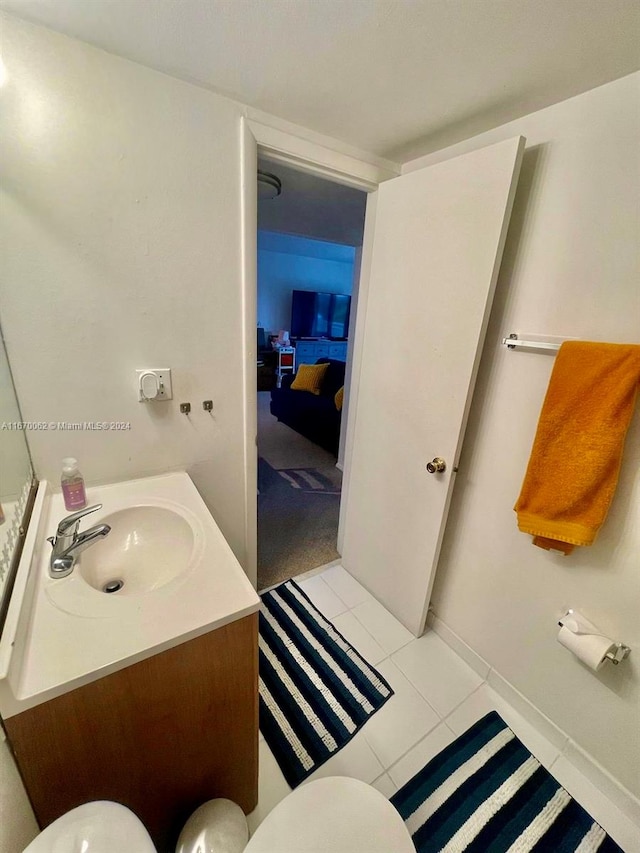 bathroom featuring vanity, toilet, and tile patterned floors