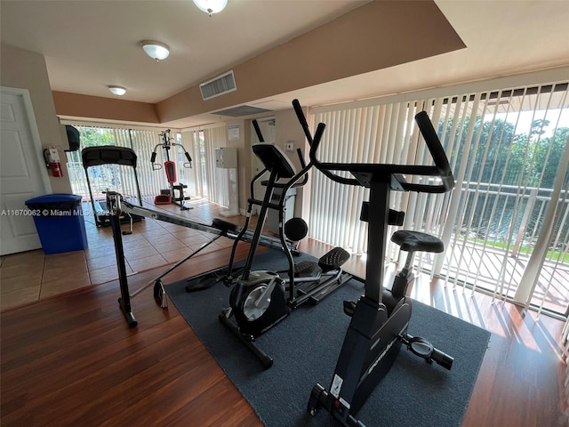 exercise room with dark wood-type flooring