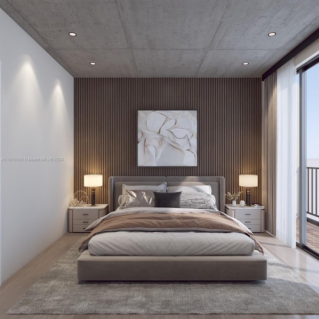 bedroom featuring wood-type flooring and access to outside