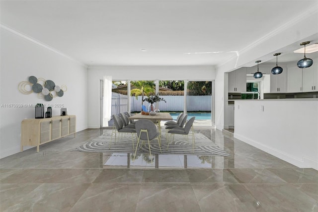 dining space featuring marble finish floor, baseboards, and ornamental molding