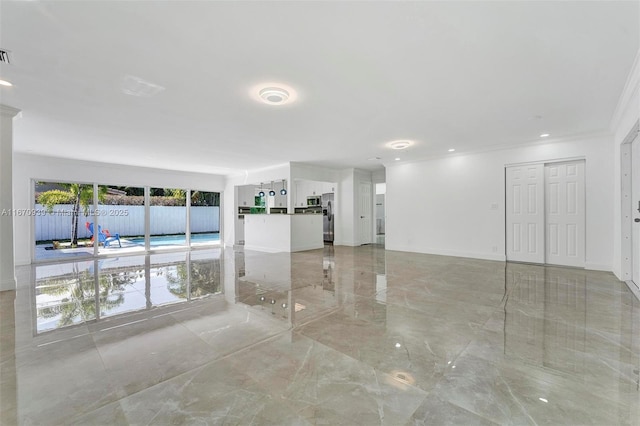 spare room featuring ornamental molding, visible vents, baseboards, and marble finish floor