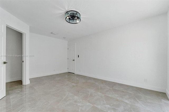 unfurnished room with visible vents and baseboards