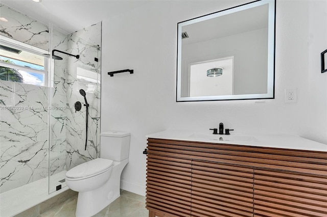 bathroom with toilet, a marble finish shower, and vanity