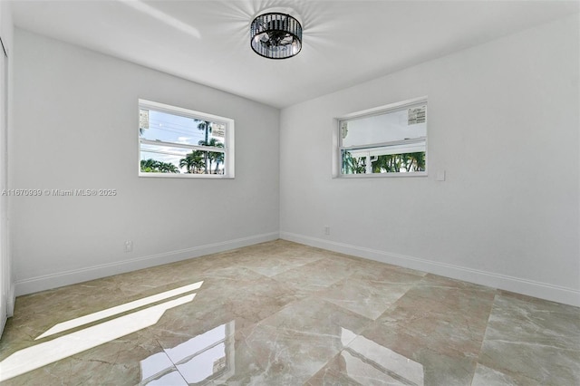 unfurnished room featuring baseboards