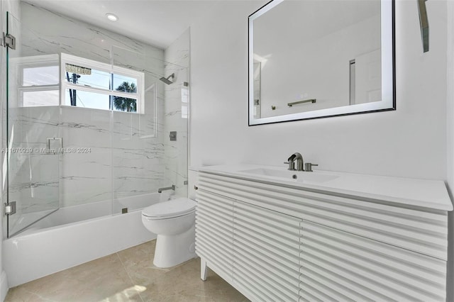 full bathroom with tile patterned flooring, shower / bath combination with glass door, toilet, and vanity