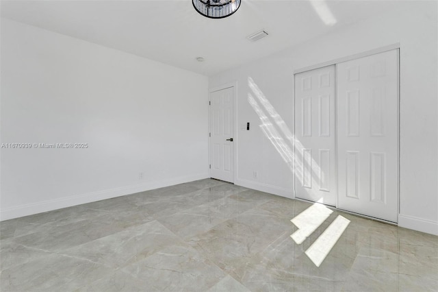 spare room with visible vents, baseboards, and marble finish floor