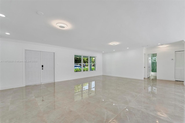 spare room featuring recessed lighting, marble finish floor, and ornamental molding