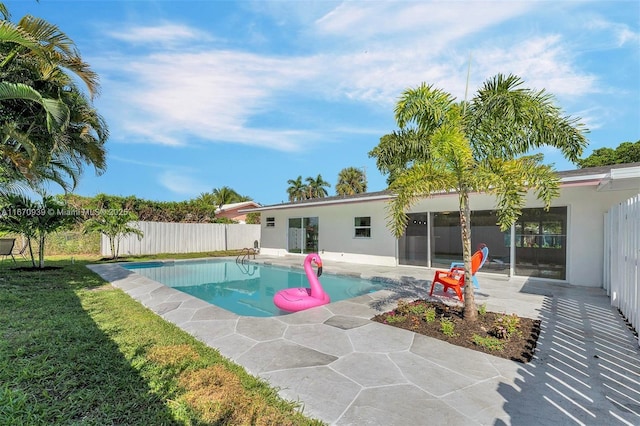 view of pool featuring a patio area, fence, a fenced in pool, and a yard