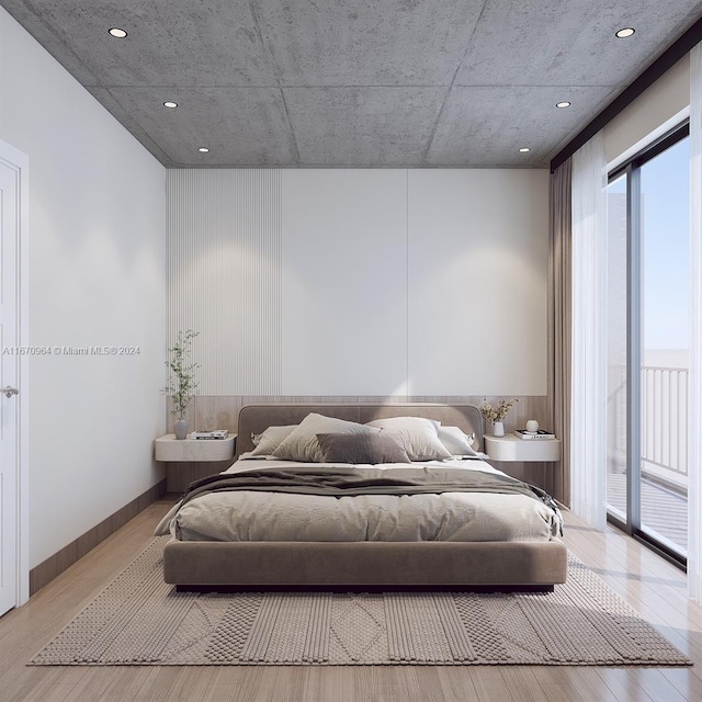 bedroom featuring light wood-type flooring and access to exterior