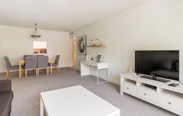 living room featuring a textured ceiling and light colored carpet