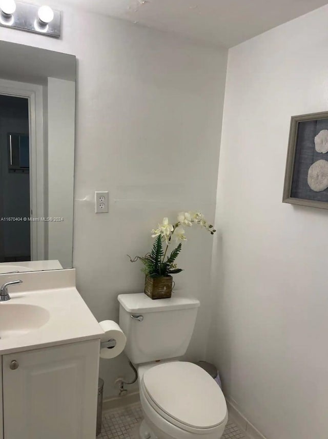 bathroom featuring tile patterned floors, vanity, and toilet