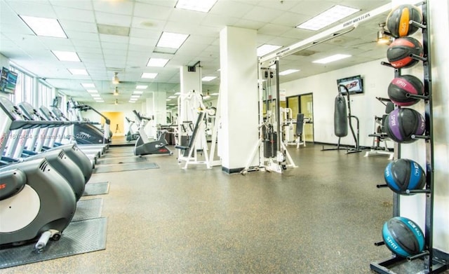 gym with a paneled ceiling