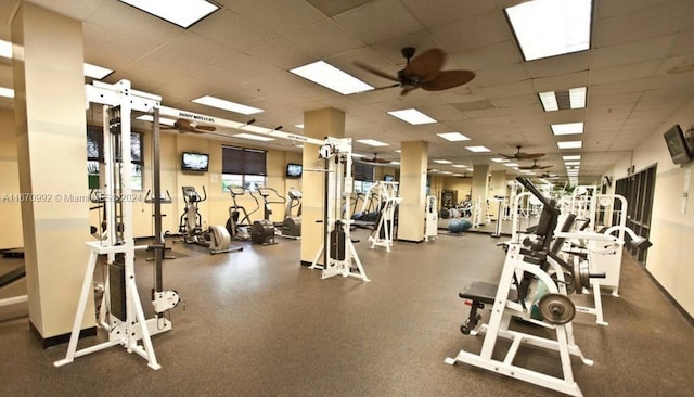 gym with a drop ceiling and ceiling fan