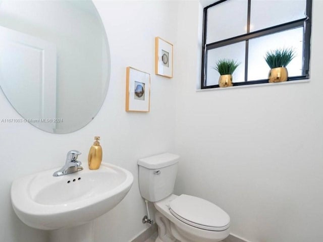 bathroom featuring sink and toilet