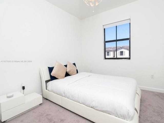 bedroom featuring light carpet