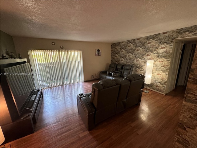 living room with a textured ceiling and dark wood-type flooring