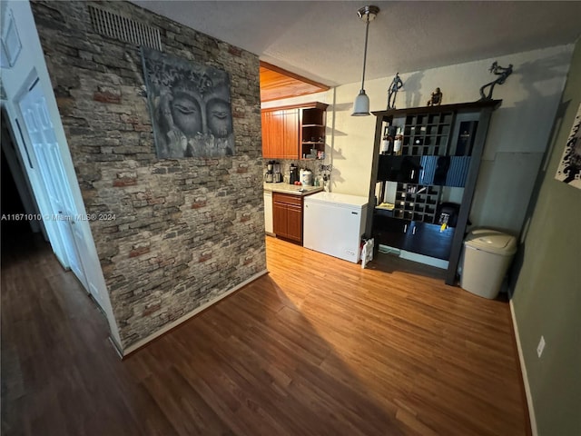 interior space featuring a textured ceiling and dark hardwood / wood-style floors