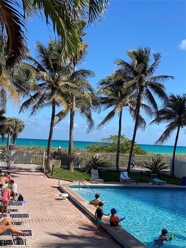 view of swimming pool with a water view