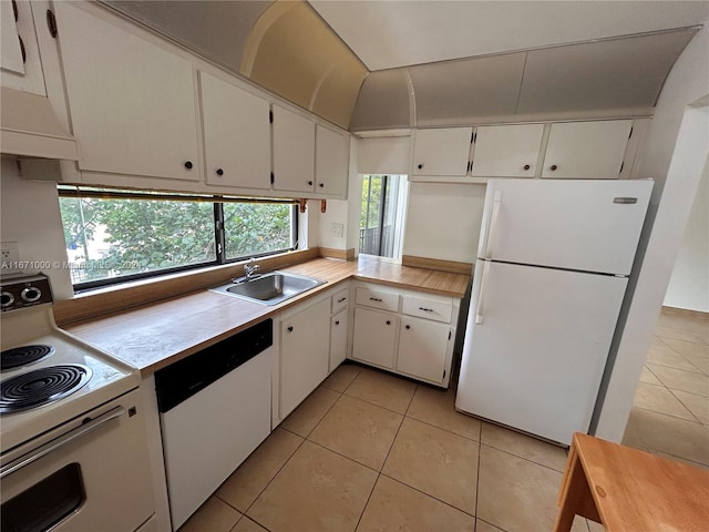 16919 N Bay Rd Unit 204, Sunny Isles Beach, FL 33160 - kitchen featuring white appliances, light countertops, white cabinets, and light tile patterned flooring
