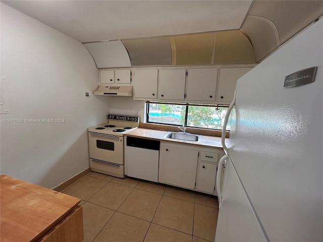 kitchen with light tile patterned floors, white appliances, white cabinetry, and sink