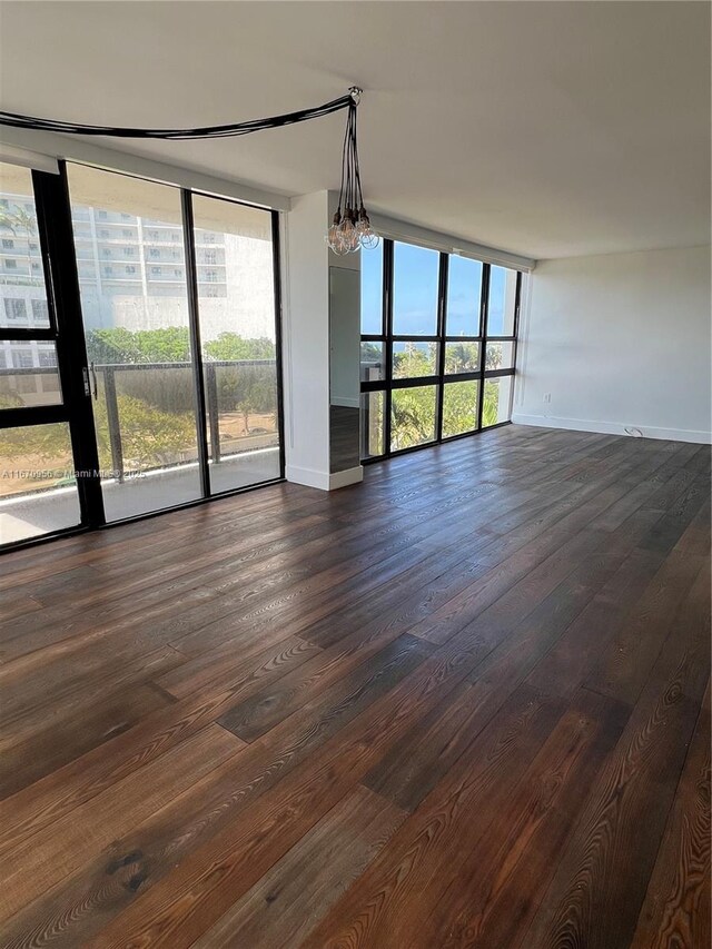 600 NE 36th St Unit 423, Miami, FL 33137 - unfurnished room with baseboards, expansive windows, and dark wood finished floors