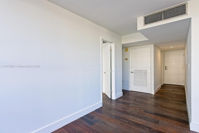 corridor featuring dark hardwood / wood-style flooring