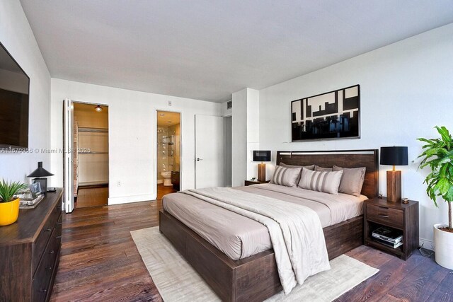 600 NE 36th St Unit 423, Miami, FL 33137 - bedroom featuring wood finished floors, baseboards, and connected bathroom