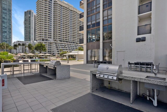 600 NE 36th St Unit 423, Miami, FL 33137 - view of patio featuring a city view, outdoor dining area, and a sink