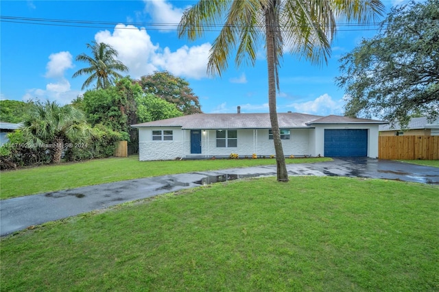 single story home with a front yard and a garage