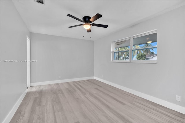 spare room featuring ceiling fan and light hardwood / wood-style flooring