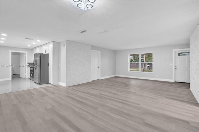 unfurnished living room with light hardwood / wood-style floors