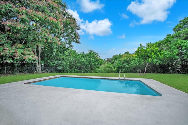 view of swimming pool featuring a yard and a patio area