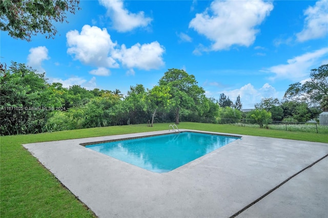 view of swimming pool with a lawn and a patio