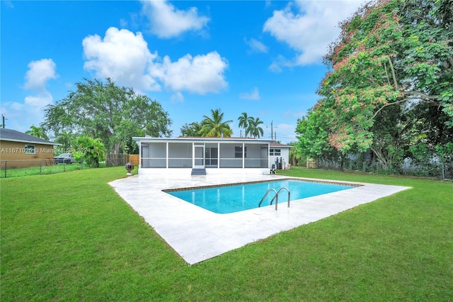 view of pool with a sunroom, a yard, and a patio