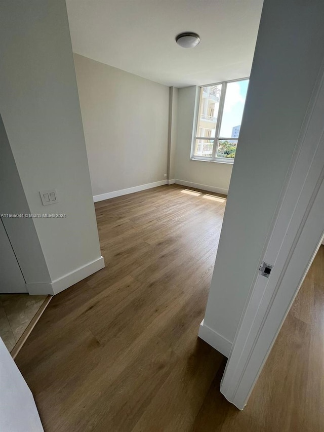 empty room featuring dark hardwood / wood-style flooring