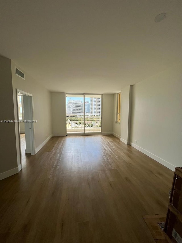 unfurnished room with dark hardwood / wood-style floors