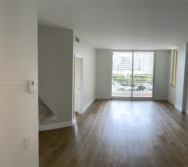 unfurnished room featuring dark hardwood / wood-style flooring