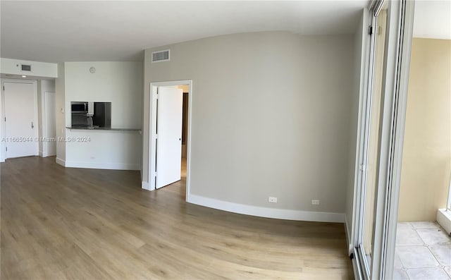 unfurnished room featuring light wood-type flooring