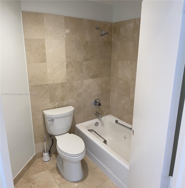 bathroom featuring tiled shower / bath combo and toilet