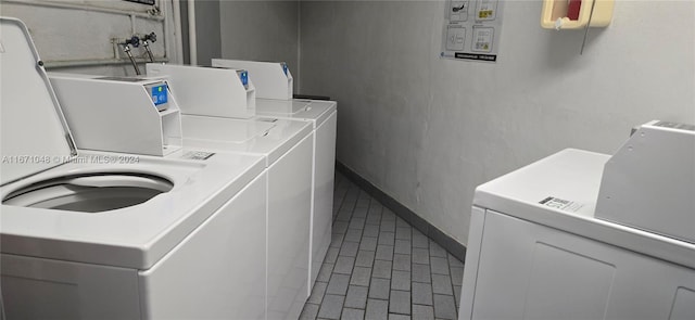 clothes washing area featuring washing machine and dryer and tile patterned floors